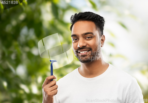 Image of indian man with razor over natural background