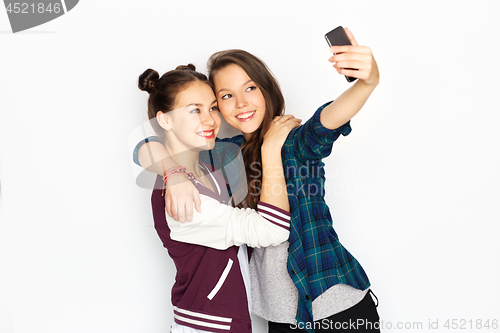 Image of happy teenage girls taking selfie by smartphone