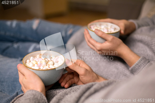 Image of close up of couple drinking hot chocolate at home