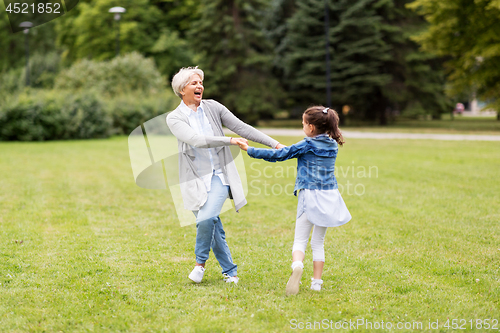 Image of grandmother and granddaughter playing at park