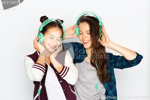 Image of teenage girls in earphones listening to music
