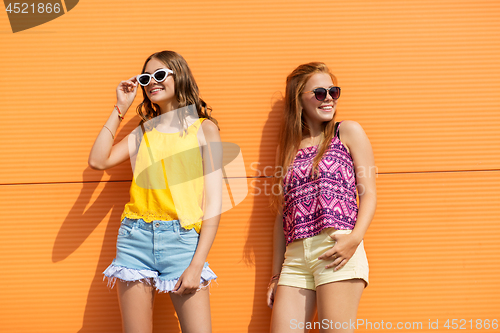 Image of smiling teenage girls in summer clothes outdoors