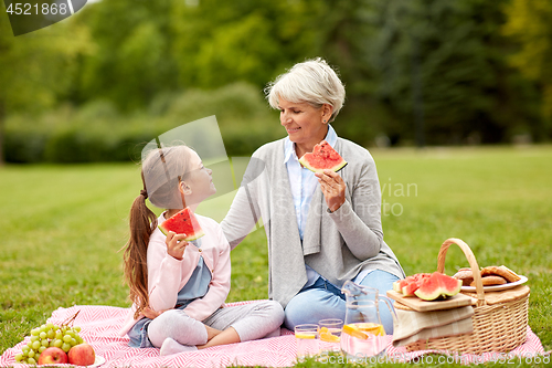 Image of grandmother and granddaughter at picnic in park