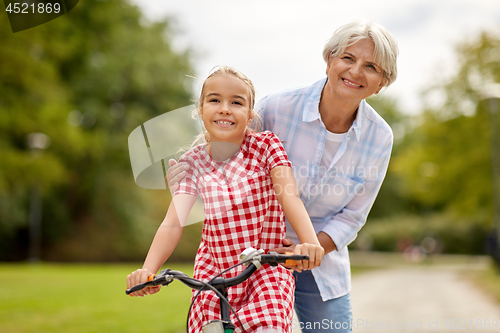 Image of grandmother and granddaughter with bicycles