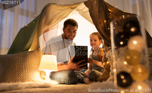 Image of family with tablet pc in kids tent at home