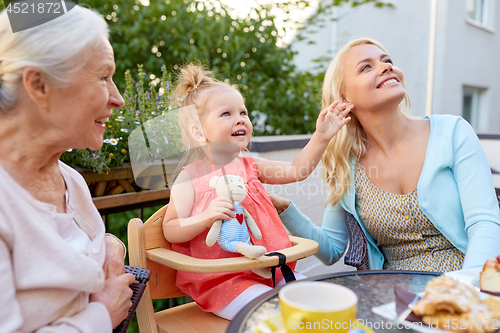 Image of mother, daughter and grandmother at cafe