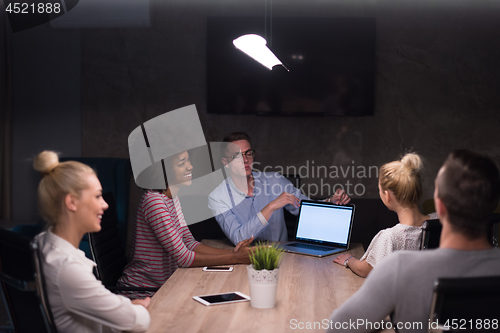 Image of Multiethnic startup business team in night office