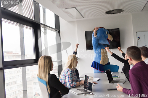 Image of boss dresed as bear having fun with business people in trendy of