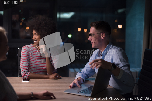 Image of Multiethnic startup business team in night office