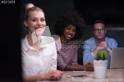 Image of Multiethnic startup business team in night office