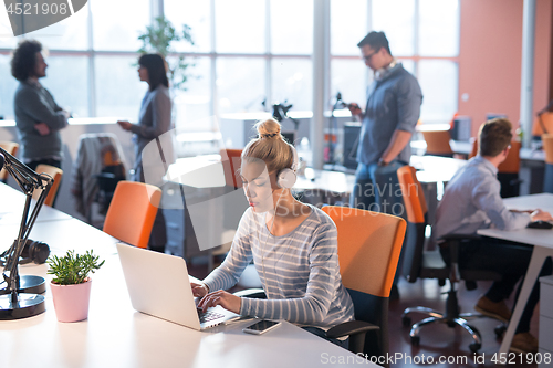 Image of businesswoman using a laptop in startup office