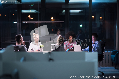 Image of Multiethnic startup business team in night office