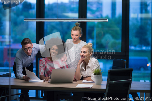 Image of Multiethnic startup business team in night office