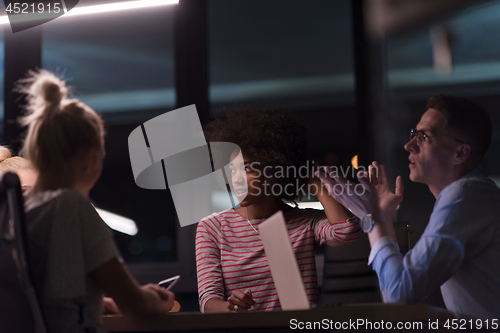 Image of Multiethnic startup business team in night office