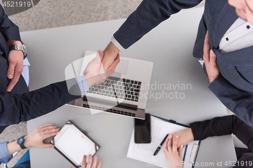 Image of cloasing the deal in modern office interior top view