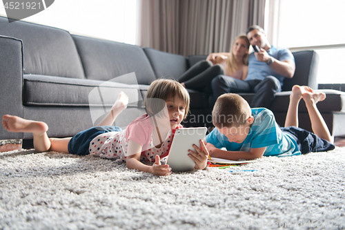 Image of young couple spending time with kids