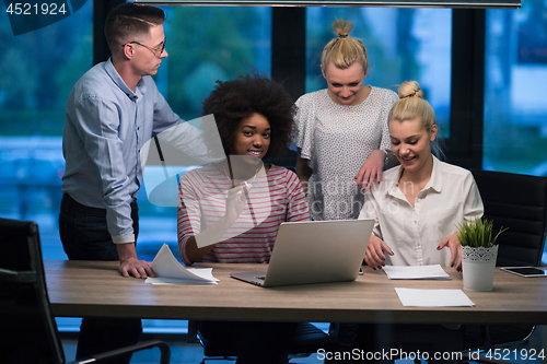 Image of Multiethnic startup business team in night office