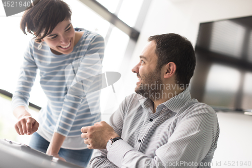 Image of Two Business People Working With Tablet in startup office