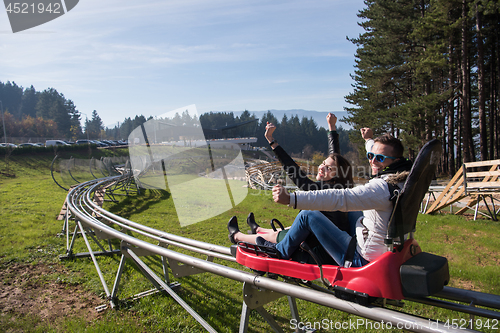 Image of couple enjoys driving on alpine coaster