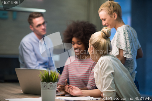 Image of Multiethnic startup business team in night office