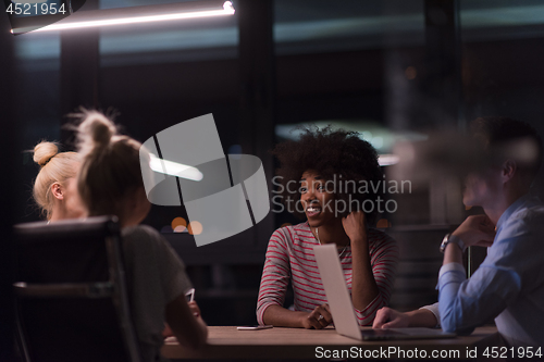 Image of Multiethnic startup business team in night office