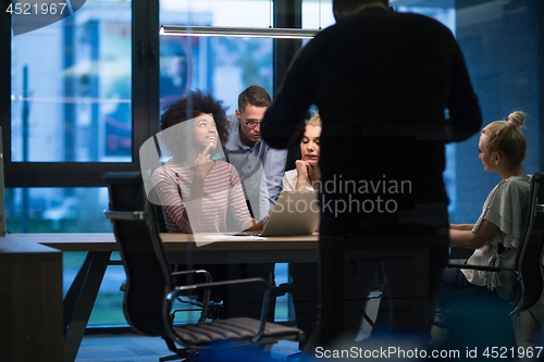 Image of Multiethnic startup business team in night office