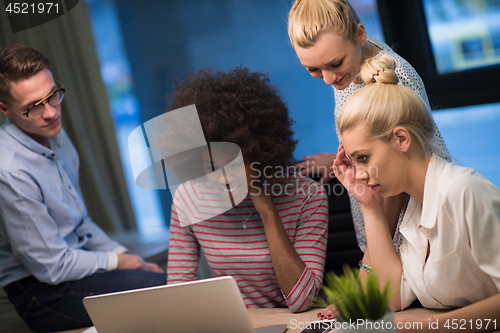 Image of Multiethnic startup business team in night office