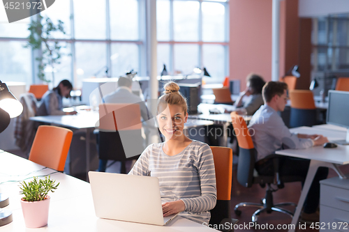 Image of businesswoman using a laptop in startup office