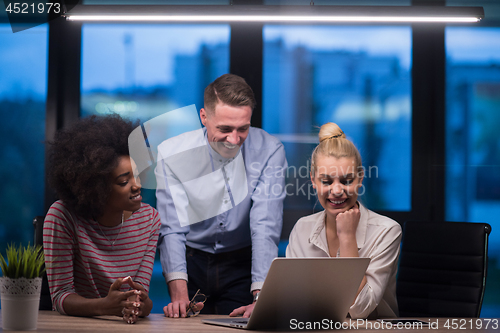 Image of Multiethnic startup business team in night office