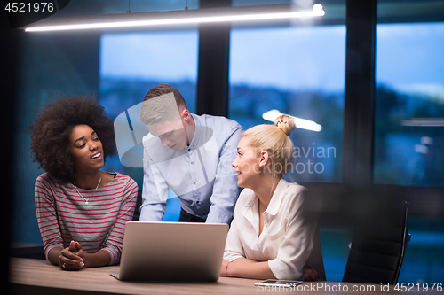 Image of Multiethnic startup business team in night office