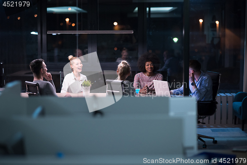 Image of Multiethnic startup business team in night office