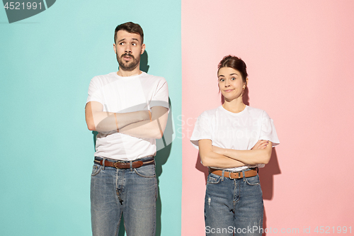 Image of Let me think. Doubtful pensive couple with thoughtful expression making choice against pink background