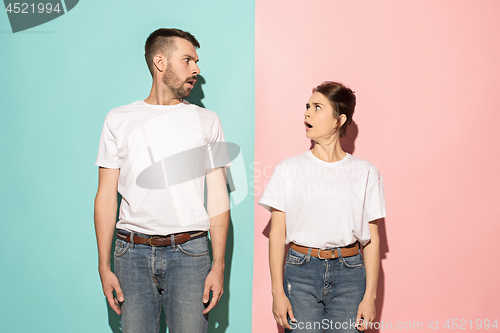 Image of Wow. Doubtful pensive couple with thoughtful expression making choice against pink background