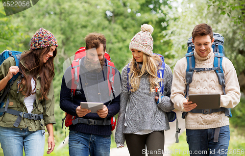 Image of friends or travelers with backpacks and tablet pc