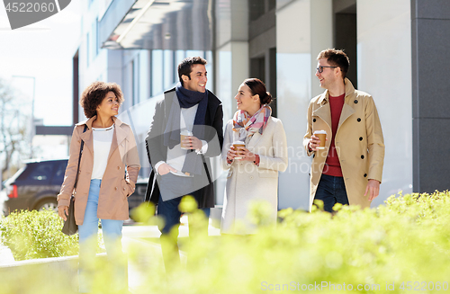 Image of office workers with coffee on city street