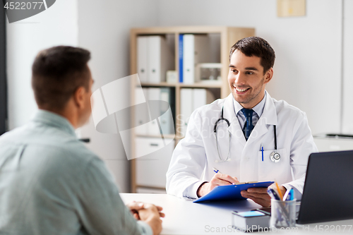 Image of doctor with clipboard and male patient at hospital