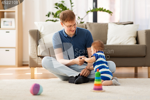 Image of happy father with baby son at home