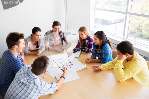 Image of group of smiling students with blueprint