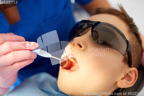 Image of boy having teeth checkup at dental clinic