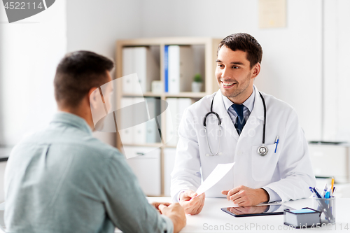 Image of doctor giving prescription to patient at hospital