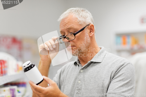 Image of senior male customer with drug at pharmacy
