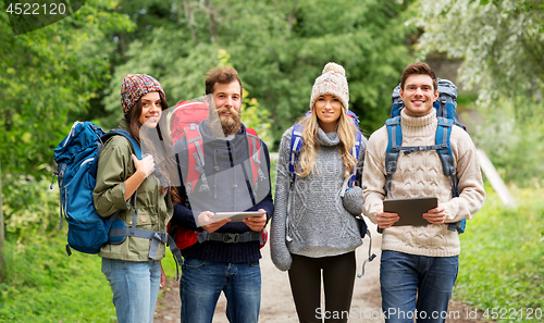 Image of friends or travelers with backpacks and tablet pc