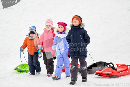 Image of happy little kids with sleds in winter