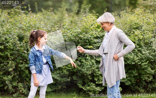 Image of grandma and granddaughter with insect repellent