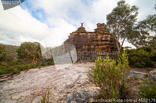 Image of Hiker on top of a rocky pagoda castle