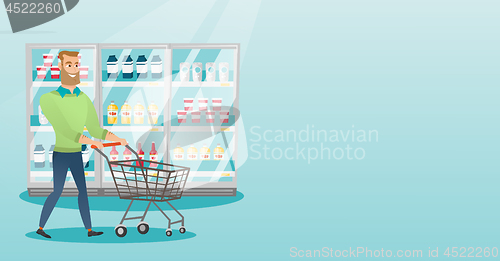 Image of Young caucasian man with supermarket trolley.