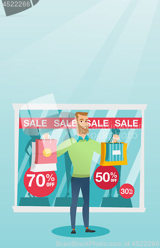 Image of Young caucasian man shopping on sale.