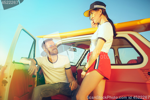 Image of Couple resting on the beach on a summer day near river