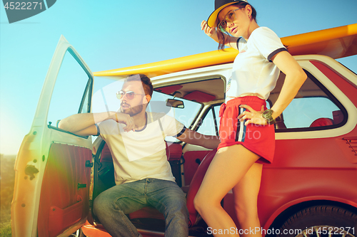 Image of Couple resting on the beach on a summer day near river