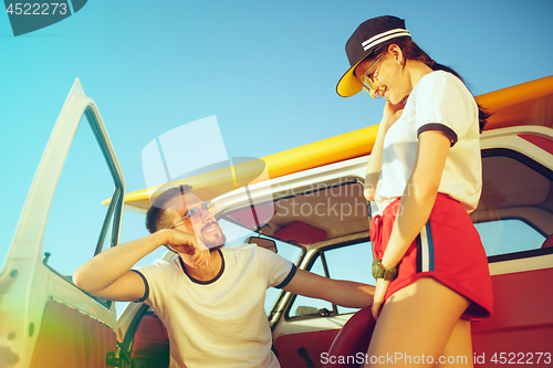 Image of Couple resting on the beach on a summer day near river